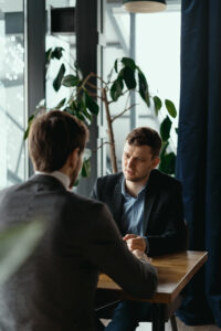 Two young businessmen discussing something